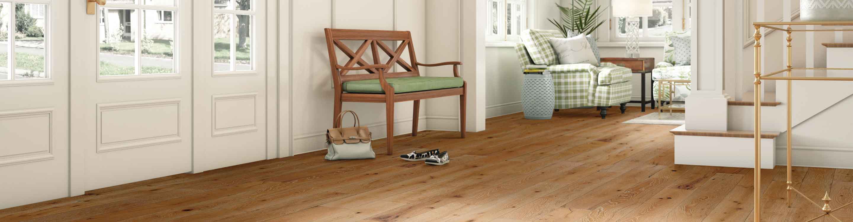 cozy entryway with lightwash hardwood flooring, green accents and white walls